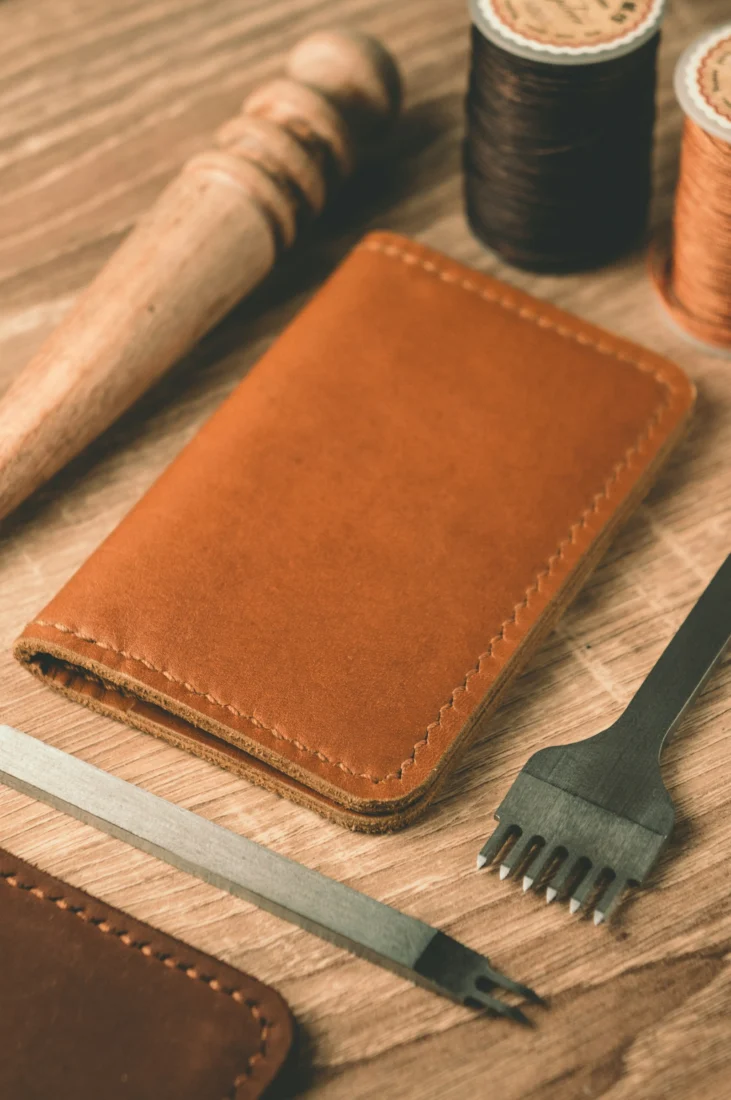 Leather wallet with thread and scissors