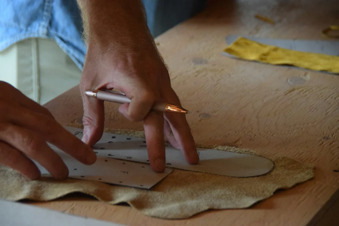 Tracing a pattern onto brown leather